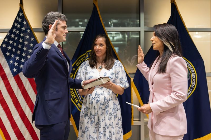 Joe Kent being sworn in as director of the National Counterterrorism Center in July 2025, with the NCTC seal and American flag in the background