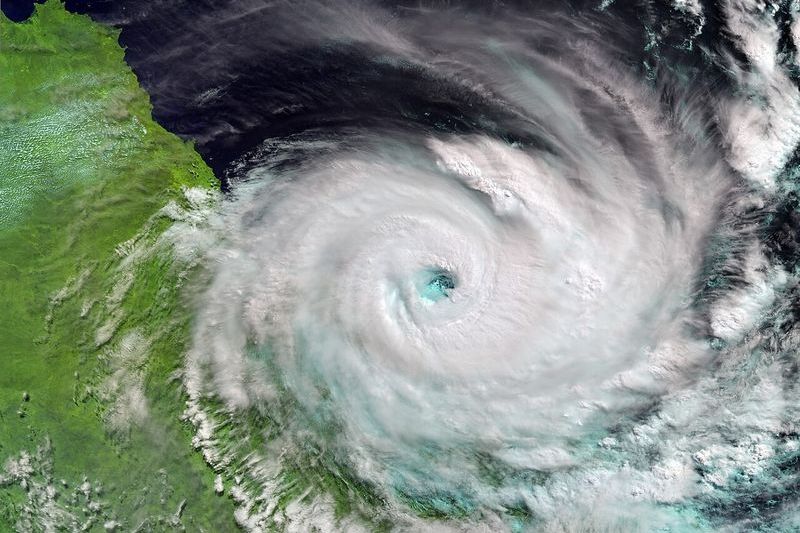 Satellite image of a tropical cyclone with a visible eye approaching the Queensland coast over the Coral Sea