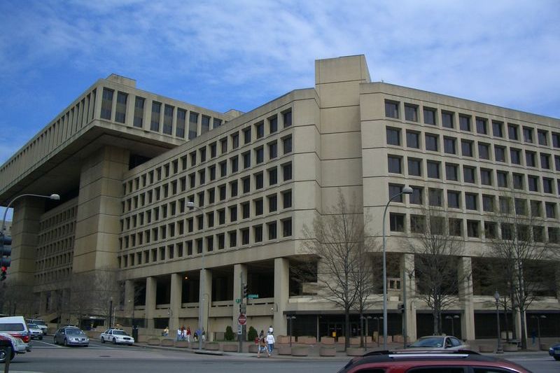 The J. Edgar Hoover FBI Building in Washington, D.C., a large brutalist concrete federal building seen from street level