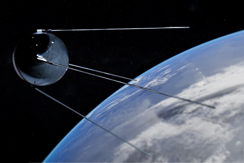 A satellite orbiting Earth in space with clouds and the planet's curved horizon visible below